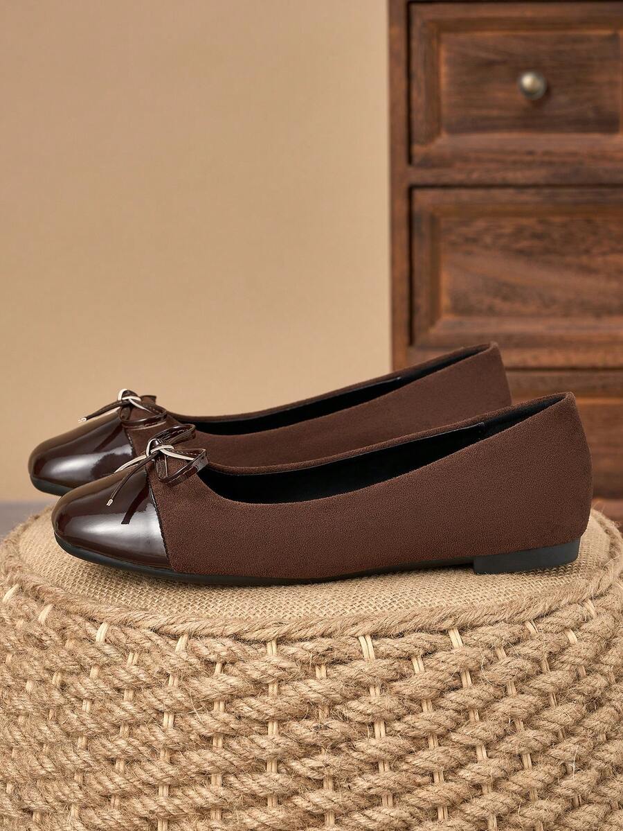 Pair of women's square toe slip-on flat shoes featuring a delicate bow detail and low vamp design.