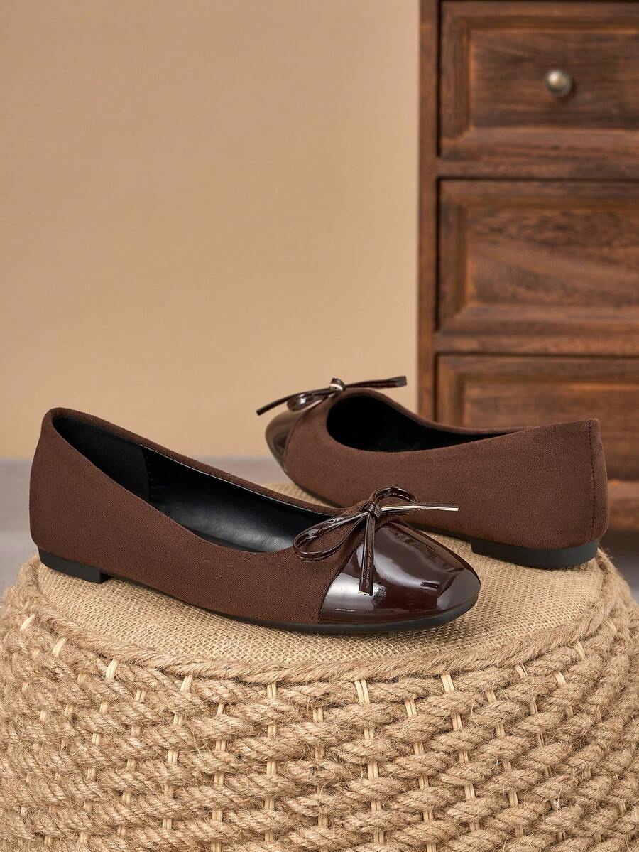 Pair of women's square toe slip-on flat shoes featuring a delicate bow detail and low vamp design.