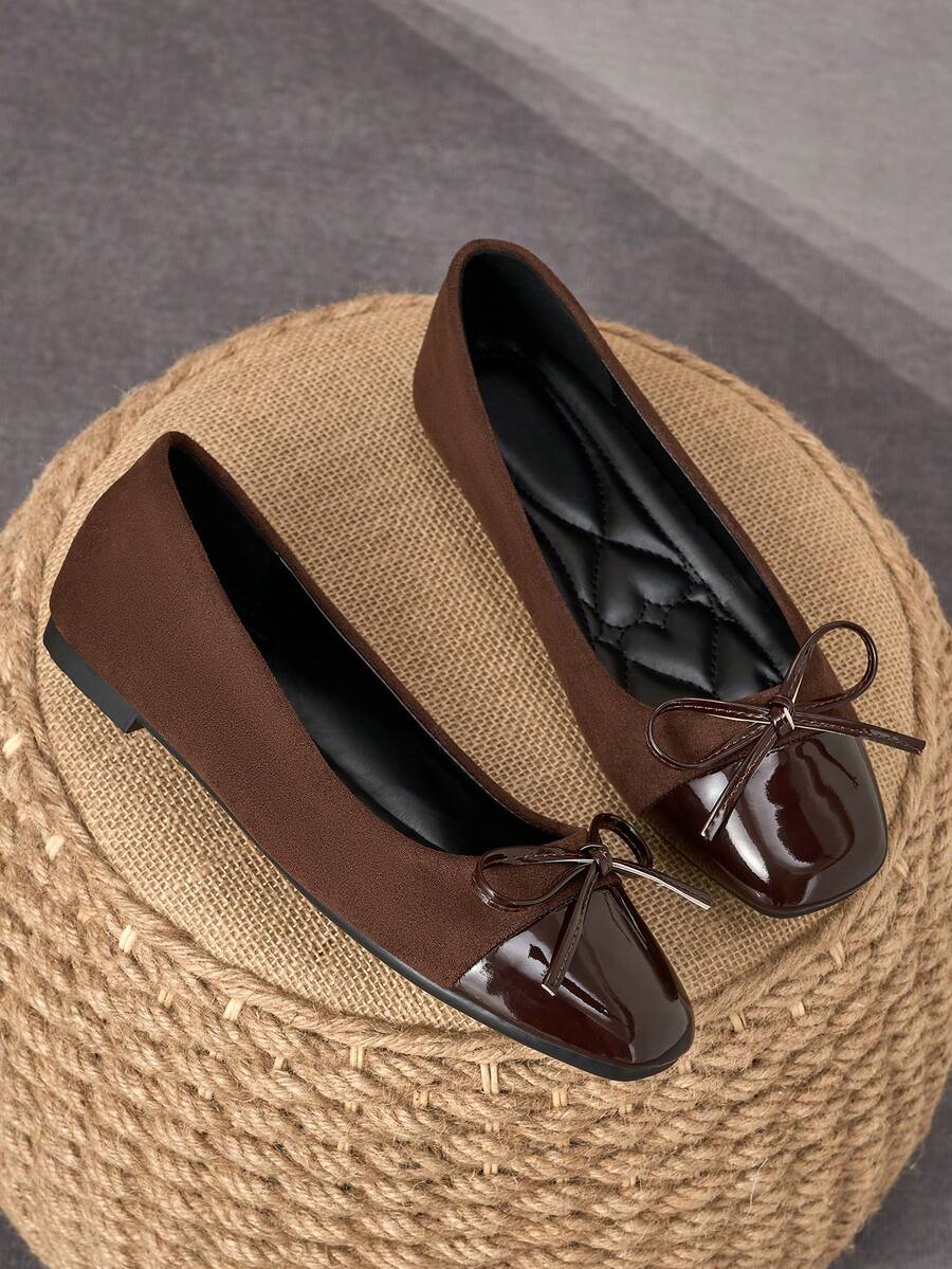Pair of women's square toe slip-on flat shoes featuring a delicate bow detail and low vamp design.