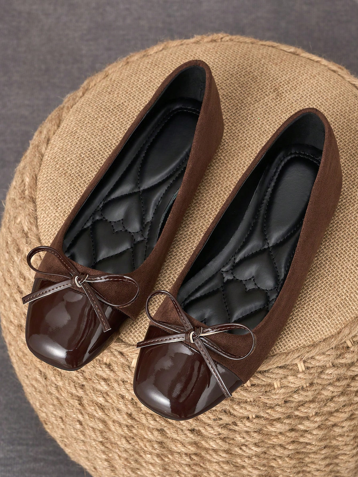 Pair of women's square toe slip-on flat shoes featuring a delicate bow detail and low vamp design.