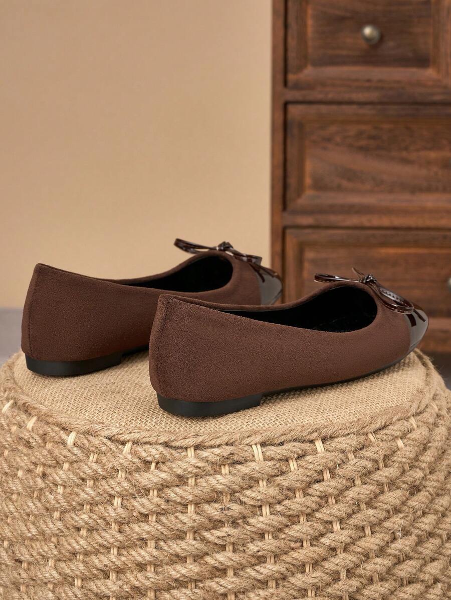 Pair of women's square toe slip-on flat shoes featuring a delicate bow detail and low vamp design.