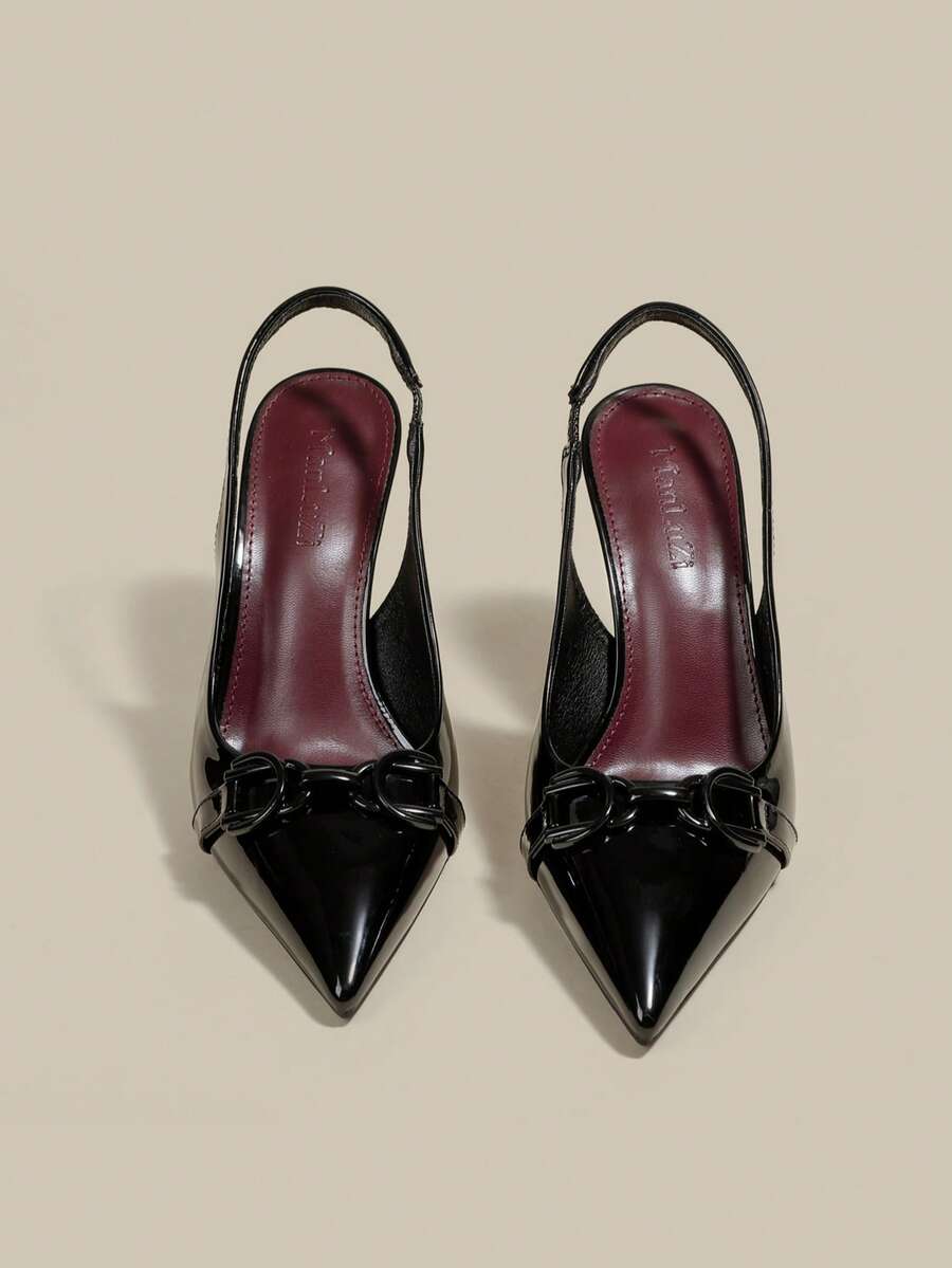 Women's pointed toe kitten heel pumps with adjustable buckle back strap and sleek patent finish.