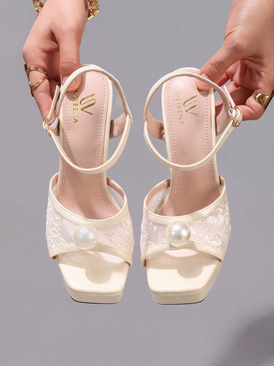 Lace embroidered open toe high heel sandals featuring a chunky square heel, platform wedge, and ankle strap buckle closure.
