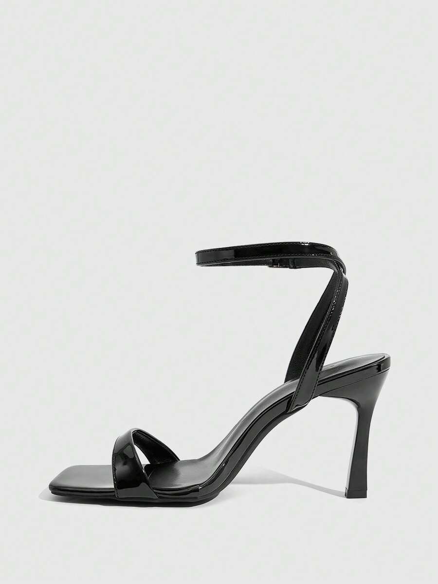 Women's high heel ankle strap sandals with open toe and stiletto heel in mirror black finish.