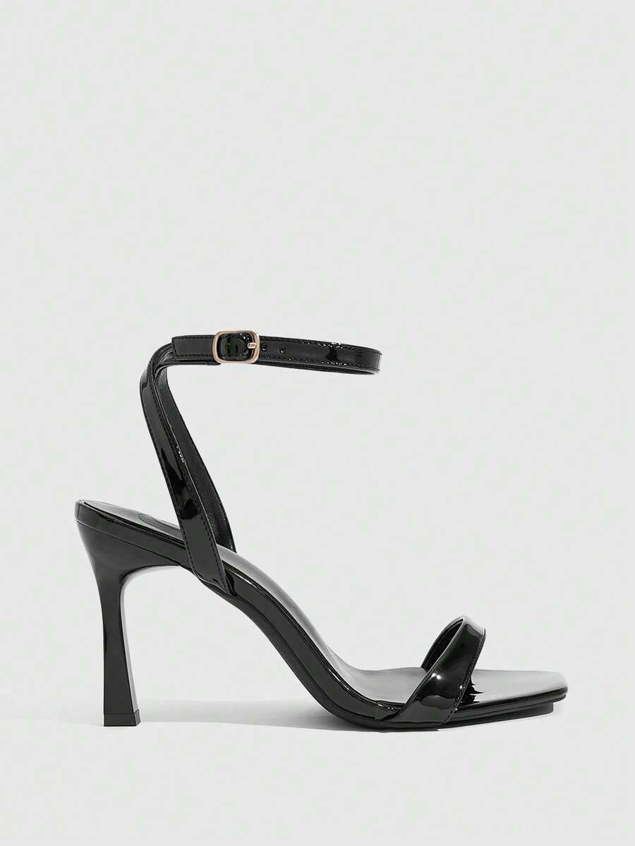 Women's high heel ankle strap sandals with open toe and stiletto heel in mirror black finish.