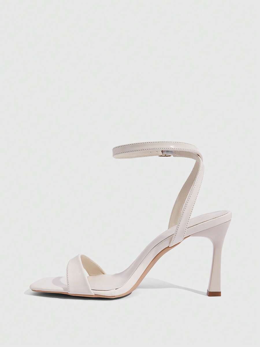 Women's high heel ankle strap sandals with open toe and stiletto heel in mirror black finish.