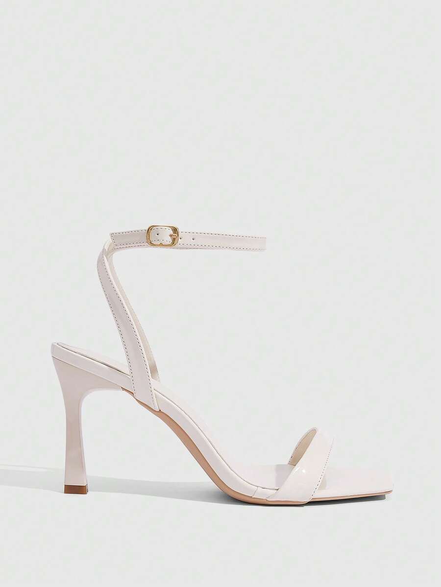 Women's high heel ankle strap sandals with open toe and stiletto heel in mirror black finish.