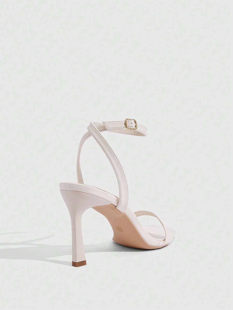 Women's high heel ankle strap sandals with open toe and stiletto heel in mirror black finish.