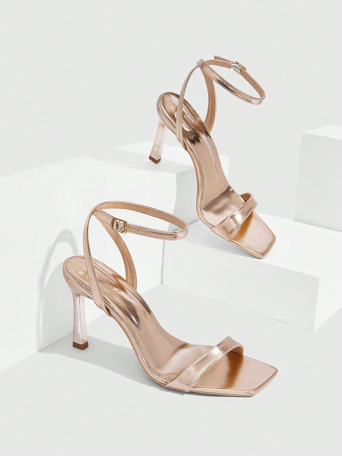 Women's high heel ankle strap sandals with open toe and stiletto heel in mirror black finish.