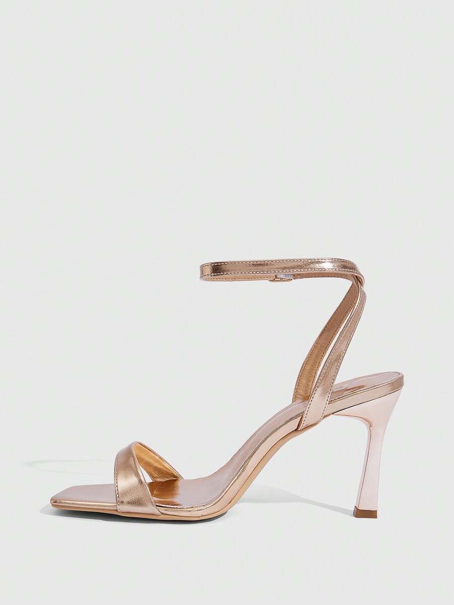 Women's high heel ankle strap sandals with open toe and stiletto heel in mirror black finish.