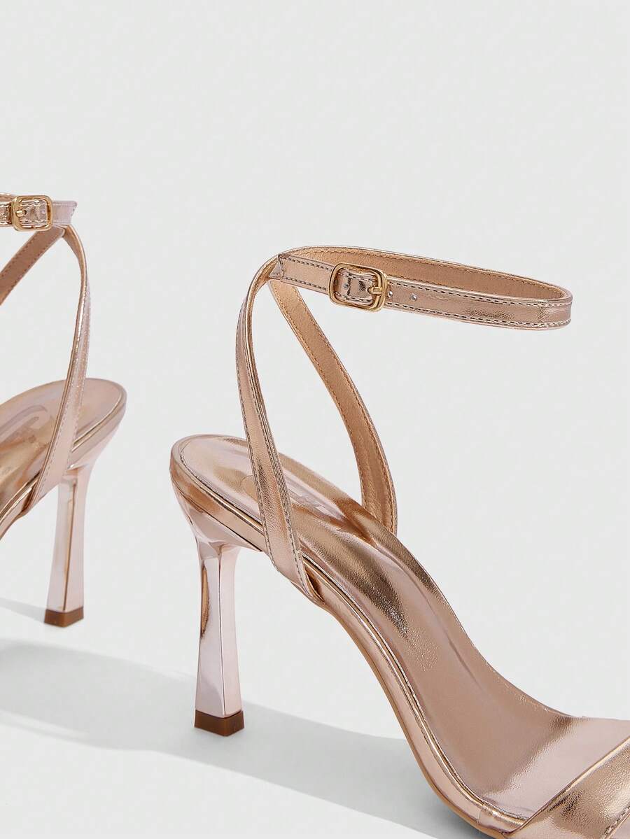Women's high heel ankle strap sandals with open toe and stiletto heel in mirror black finish.