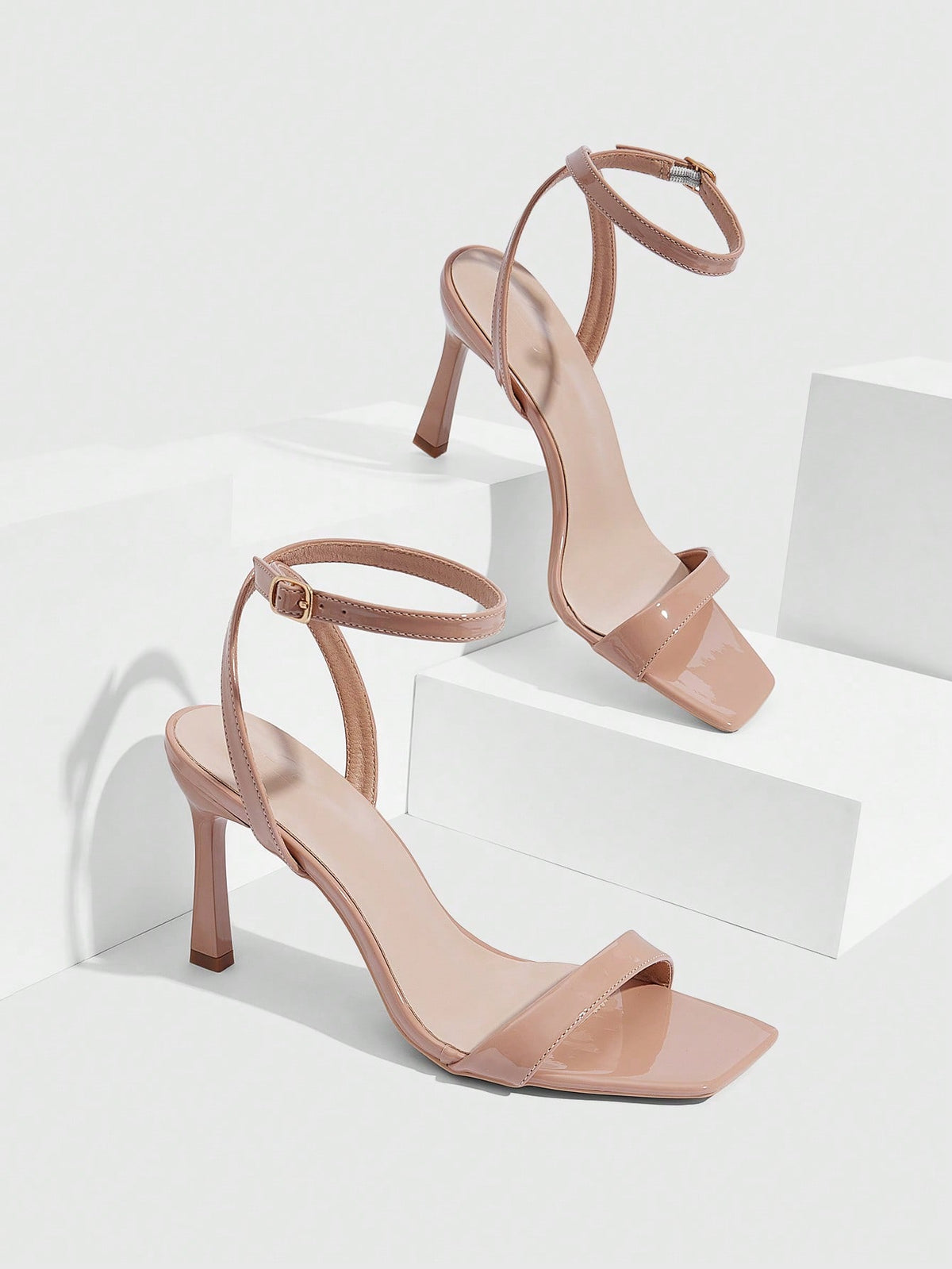 Women's high heel ankle strap sandals with open toe and stiletto heel in mirror black finish.