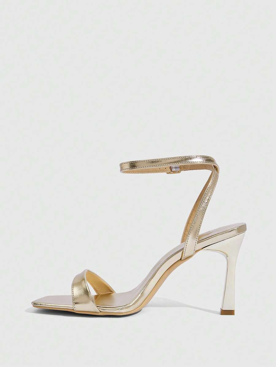 Women's high heel ankle strap sandals with open toe and stiletto heel in mirror black finish.