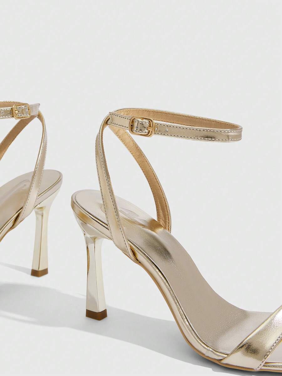 Women's high heel ankle strap sandals with open toe and stiletto heel in mirror black finish.