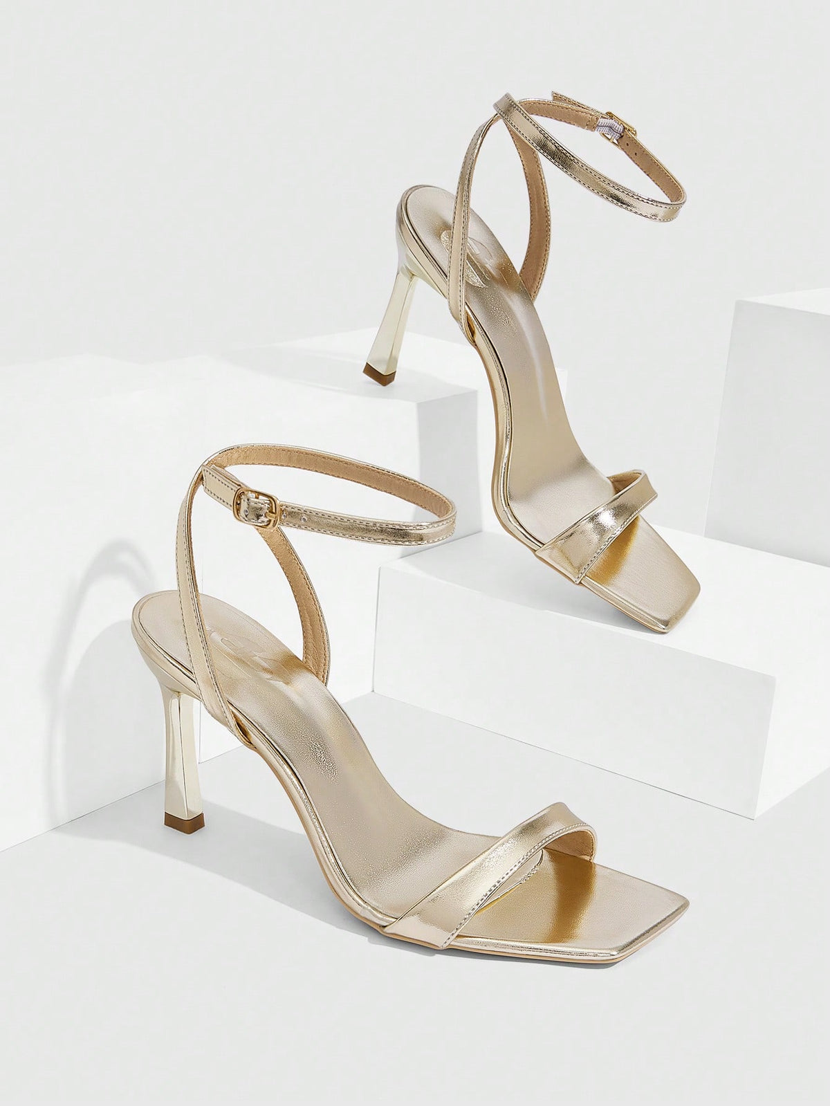 Women's high heel ankle strap sandals with open toe and stiletto heel in mirror black finish.