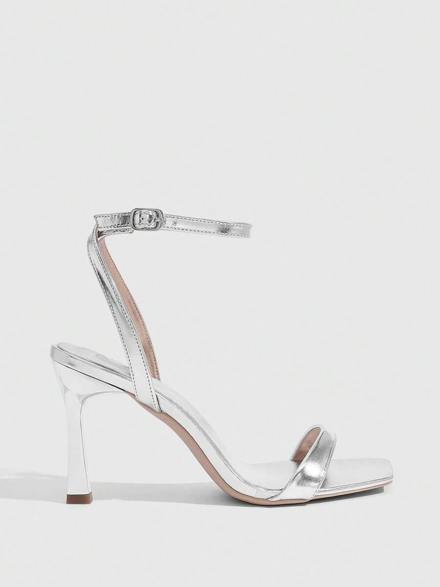 Women's high heel ankle strap sandals with open toe and stiletto heel in mirror black finish.