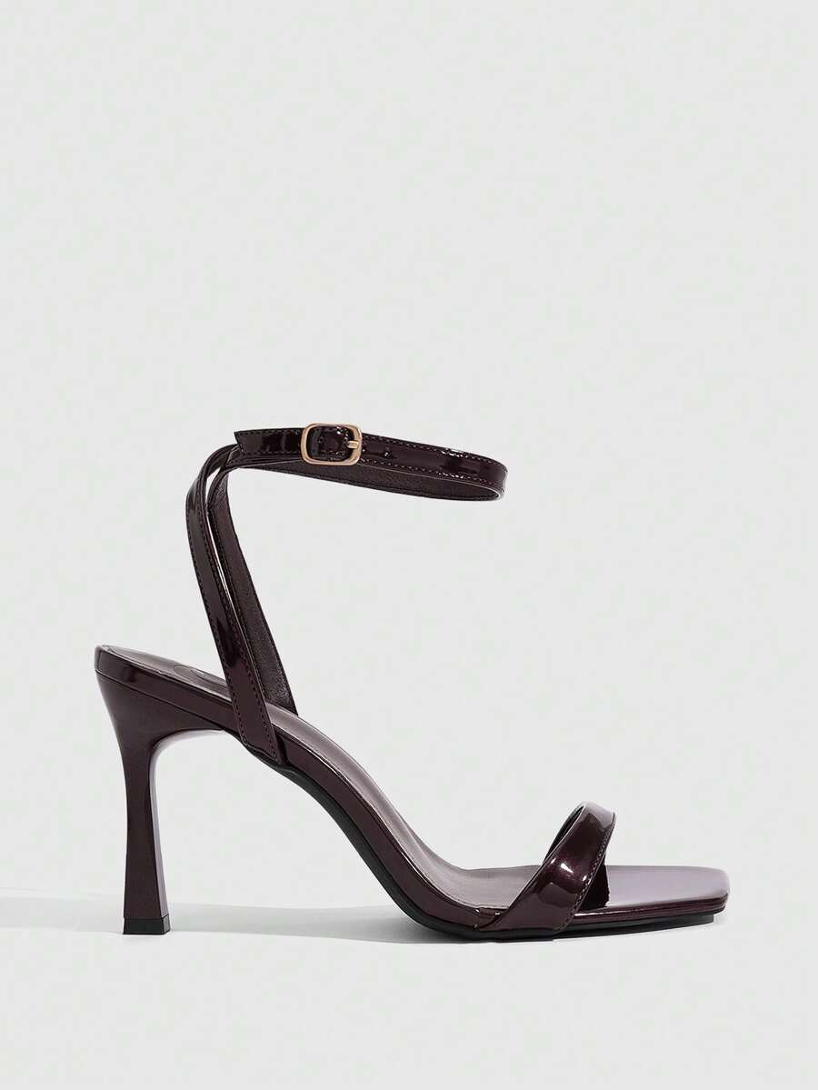 Women's high heel ankle strap sandals with open toe and stiletto heel in mirror black finish.