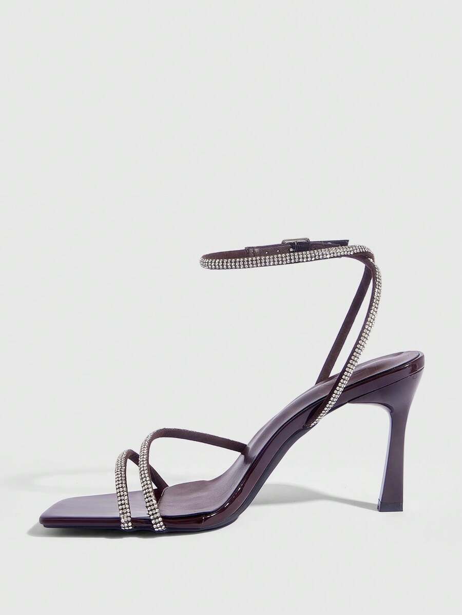 Champagne rhinestone ankle strap heeled sandals with open toe and high stiletto heel for women.