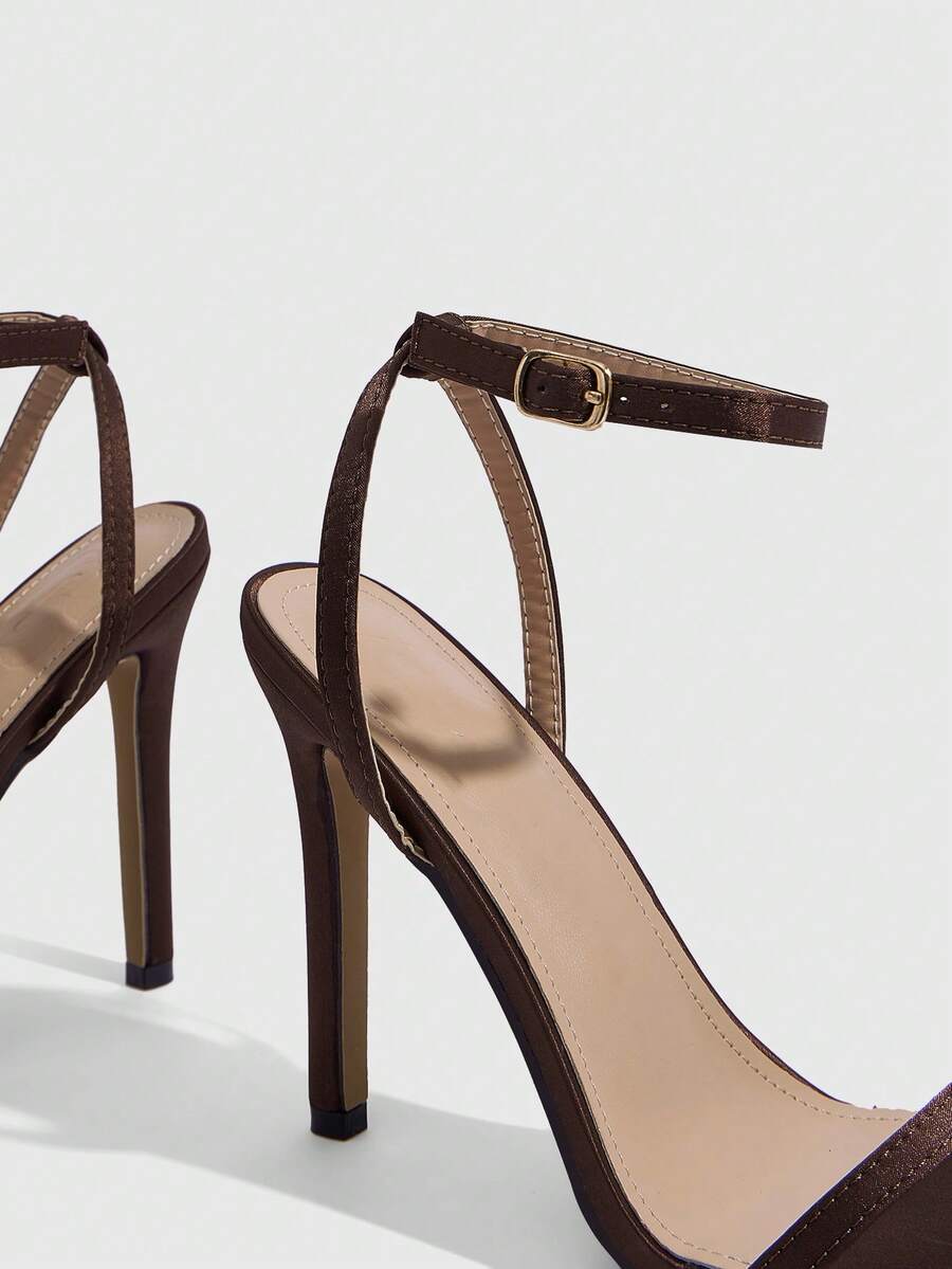 Elegant women's open toe strappy heeled sandals with stiletto high heel and ankle strap buckle closure.