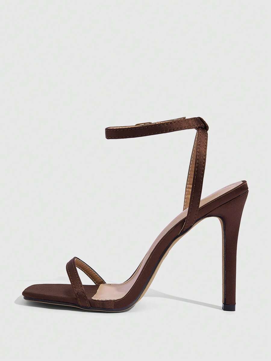 Elegant women's open toe strappy heeled sandals with stiletto high heel and ankle strap buckle closure.