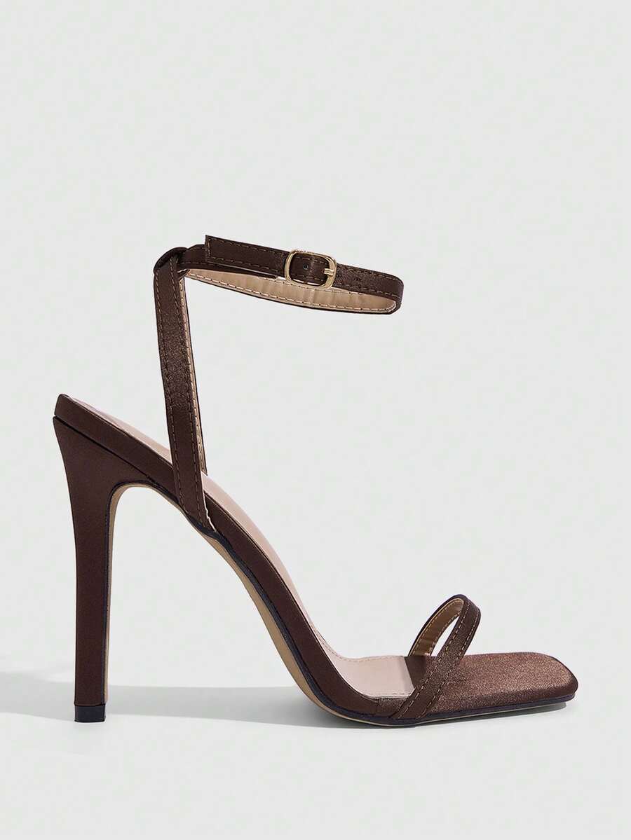 Elegant women's open toe strappy heeled sandals with stiletto high heel and ankle strap buckle closure.