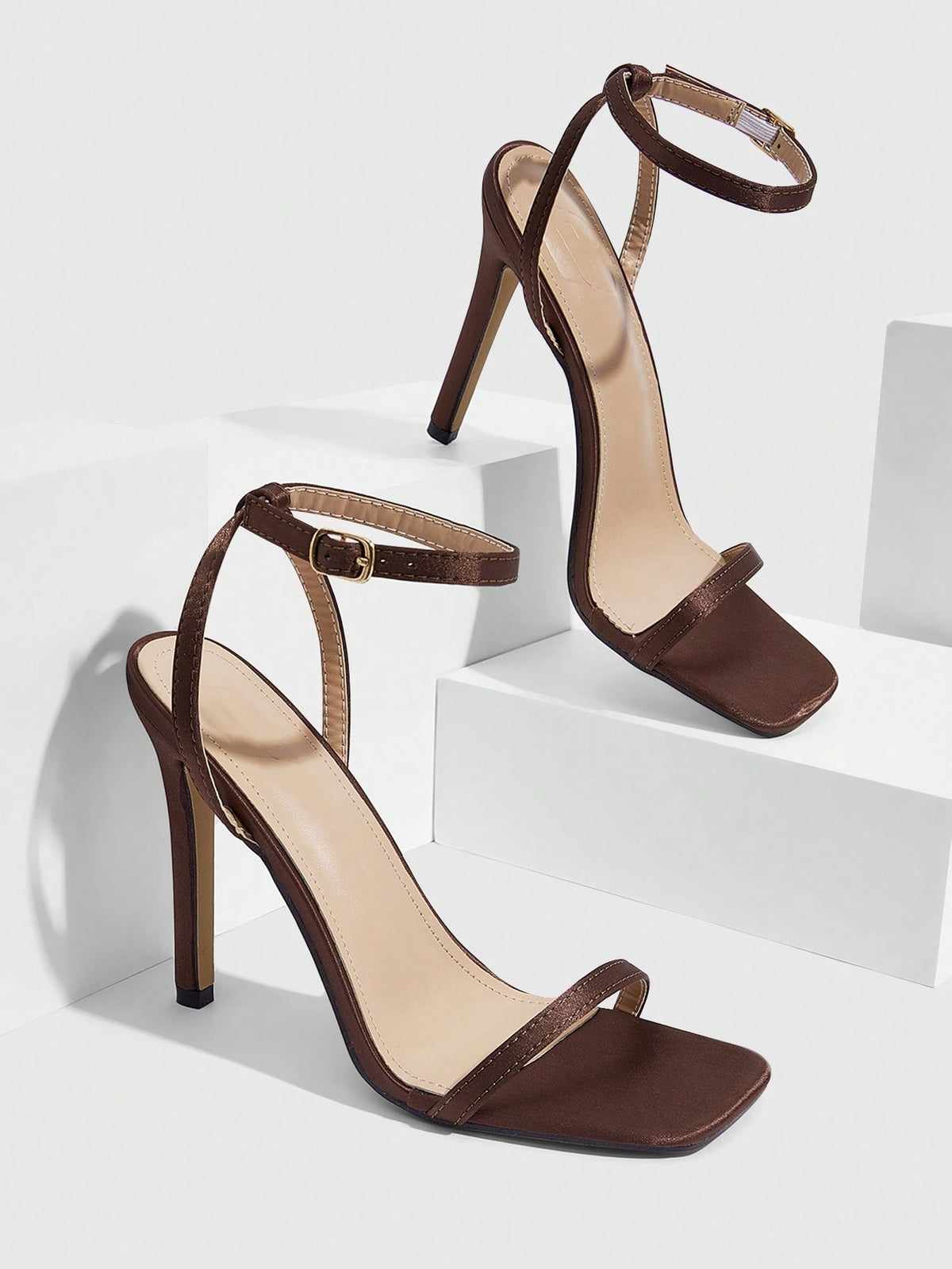 Elegant women's open toe strappy heeled sandals with stiletto high heel and ankle strap buckle closure.