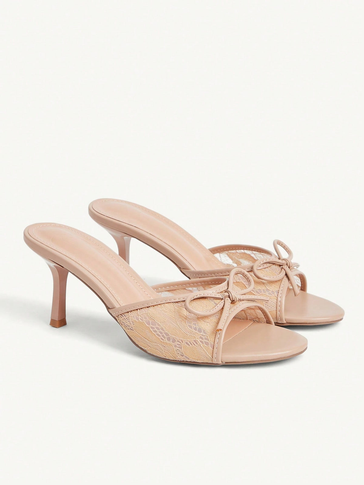 Open toe high heel slide sandals featuring lace details and a bow accent on the upper strap.