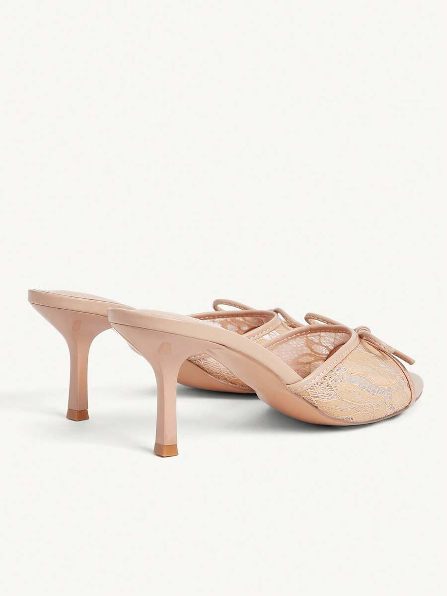 Open toe high heel slide sandals featuring lace details and a bow accent on the upper strap.