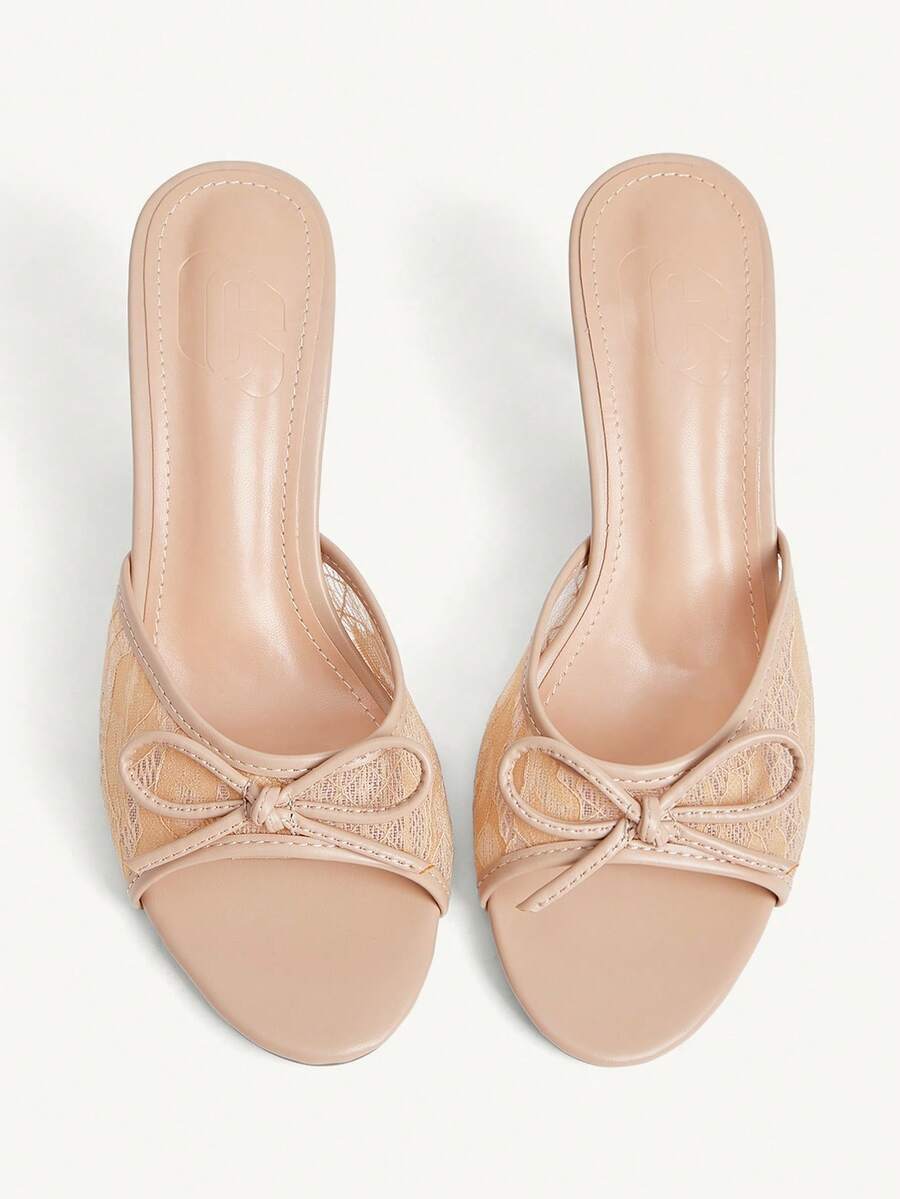 Open toe high heel slide sandals featuring lace details and a bow accent on the upper strap.