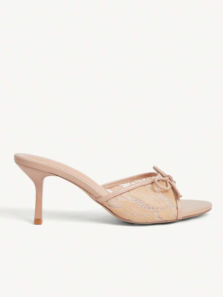 Open toe high heel slide sandals featuring lace details and a bow accent on the upper strap.