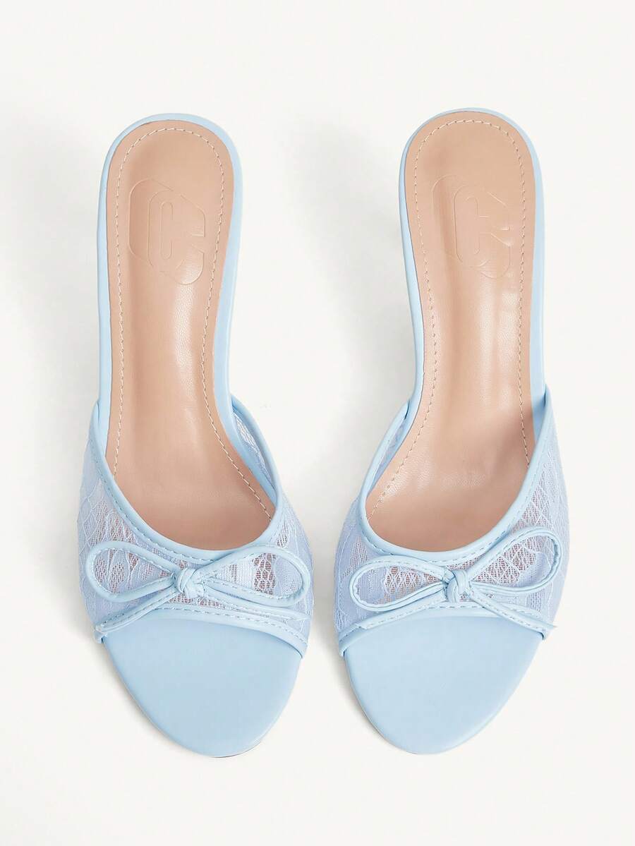 Open toe high heel slide sandals featuring lace details and a bow accent on the upper strap.