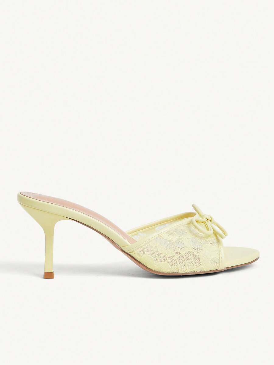 Open toe high heel slide sandals featuring lace details and a bow accent on the upper strap.