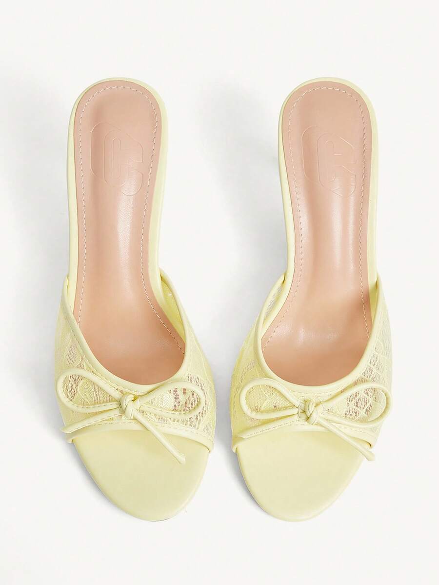 Open toe high heel slide sandals featuring lace details and a bow accent on the upper strap.
