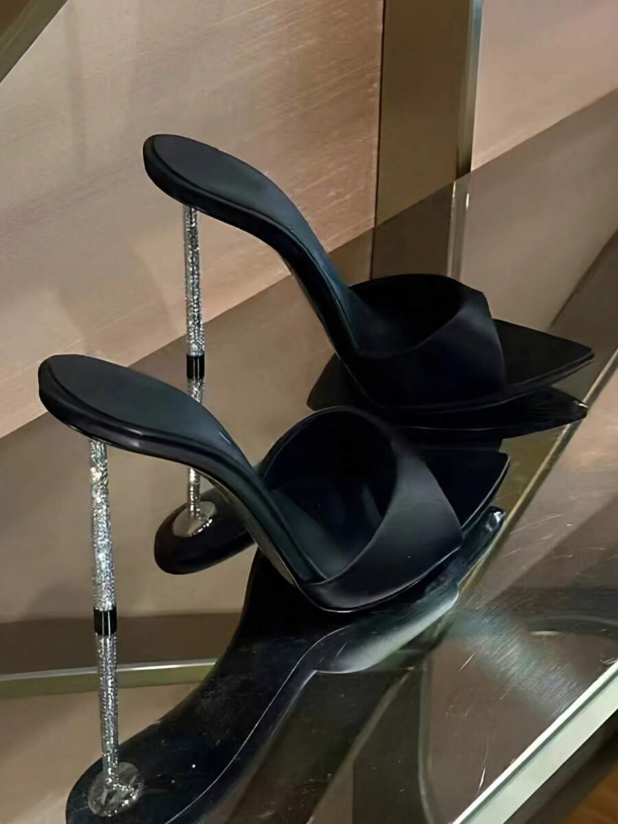 Women's black satin stiletto heeled sandals with sparkling rhinestone embellishments and a pointed peep toe design.