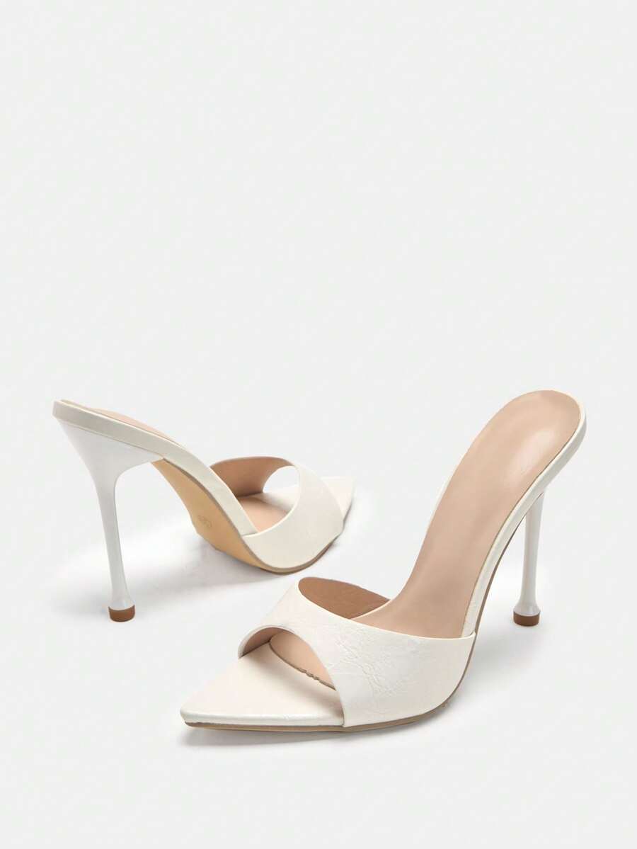 Pointed toe bowknot stiletto high heel mule sandals in white featuring a sleek slip-on open back design
