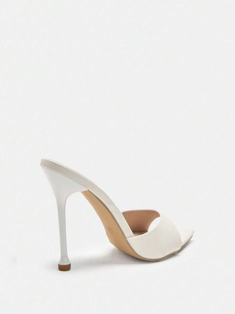 Pointed toe bowknot stiletto high heel mule sandals in white featuring a sleek slip-on open back design
