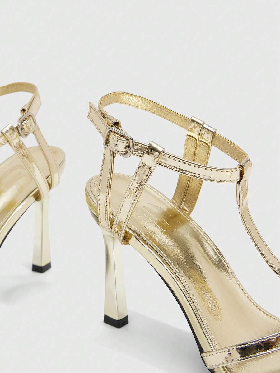 Milk apricot open toe high-heeled sandals with adjustable ankle buckle strap and stiletto heel for ladies.