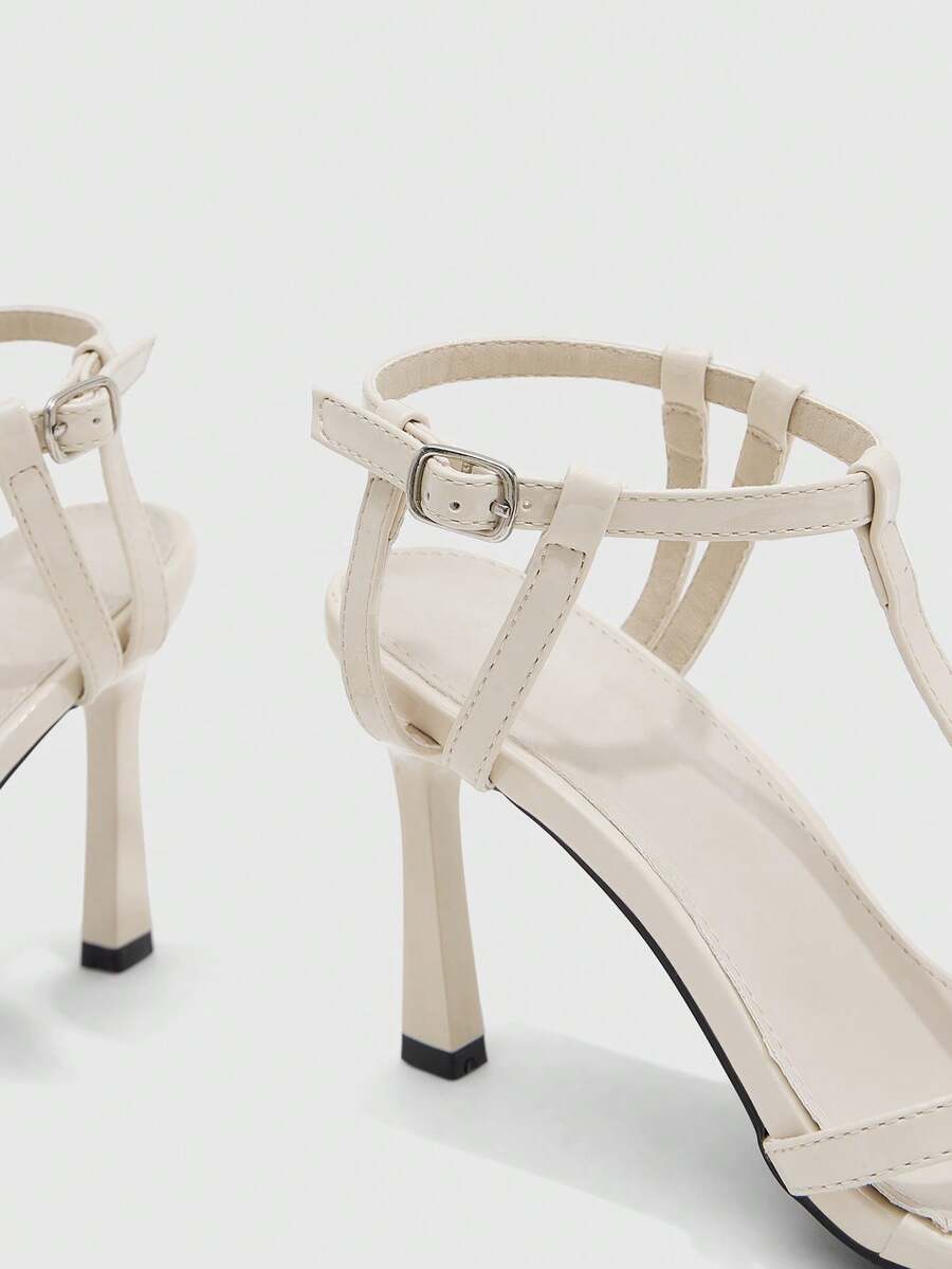 Milk apricot open toe high-heeled sandals with adjustable ankle buckle strap and stiletto heel for ladies.