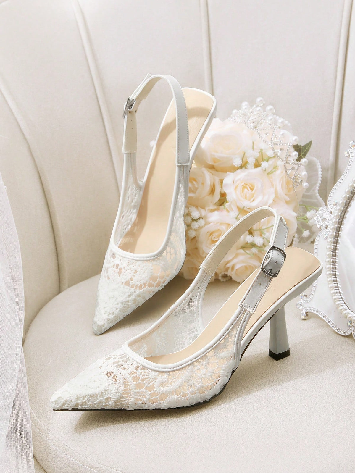 Pointed toe stiletto high heel pumps featuring black lace mesh upper, buckle slingback detail, and sleek slip-on design for weddings and evening wear.