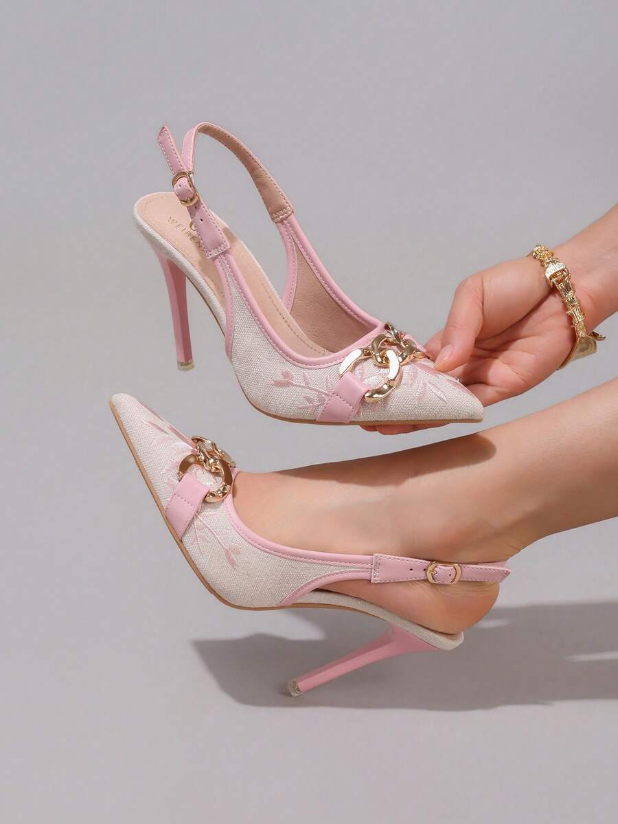 Lace embroidered high heels with thin stiletto heel, pointed toe, rhinestone embellishments, and ankle strap buckle closure.