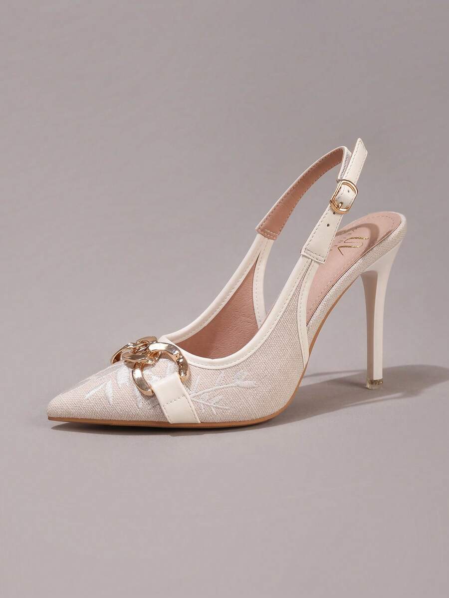 Lace embroidered high heels with thin stiletto heel, pointed toe, rhinestone embellishments, and ankle strap buckle closure.