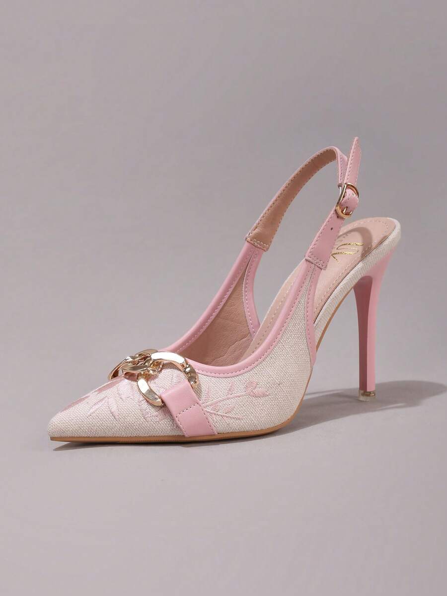 Lace embroidered high heels with thin stiletto heel, pointed toe, rhinestone embellishments, and ankle strap buckle closure.
