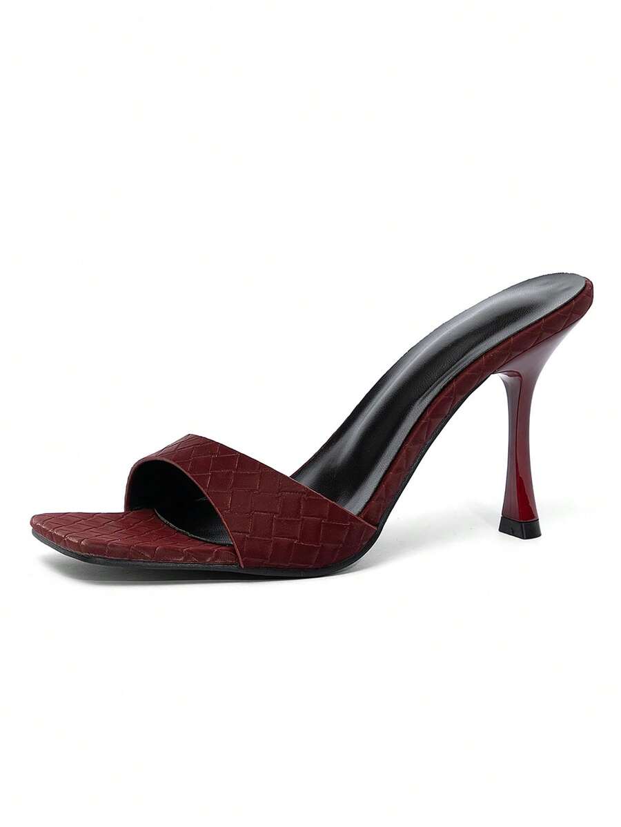 Square toe hollow out mule sandals featuring high stiletto heels and cut out upper design in smooth faux leather.