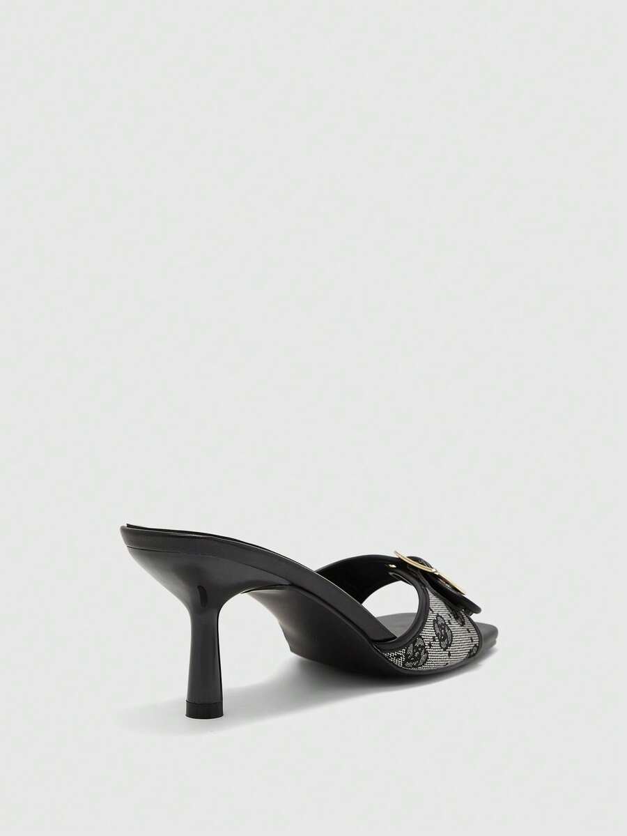 Beige women's slip-on kitten heel slide sandals featuring an accent buckle with grommet eyelets.