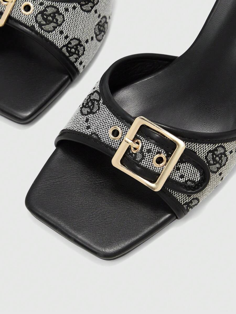 Beige women's slip-on kitten heel slide sandals featuring an accent buckle with grommet eyelets.