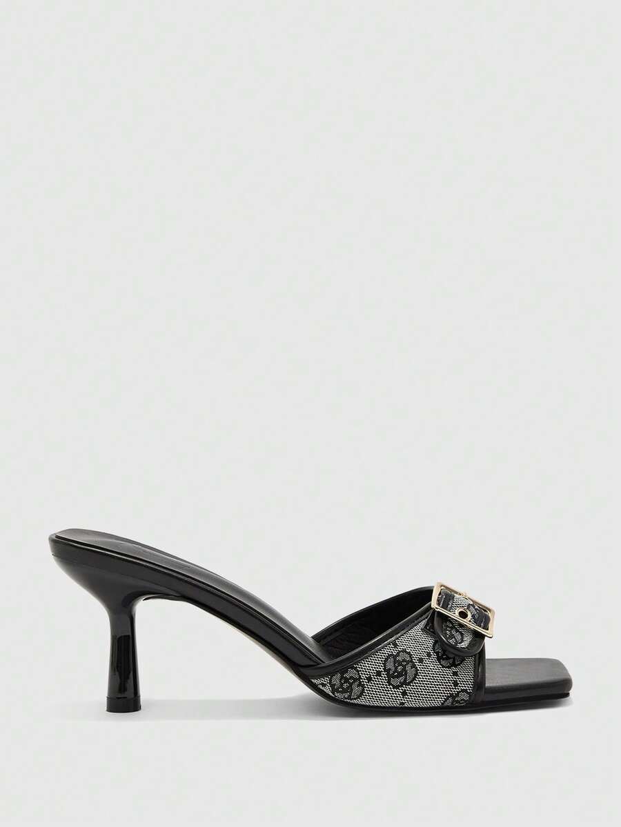 Beige women's slip-on kitten heel slide sandals featuring an accent buckle with grommet eyelets.