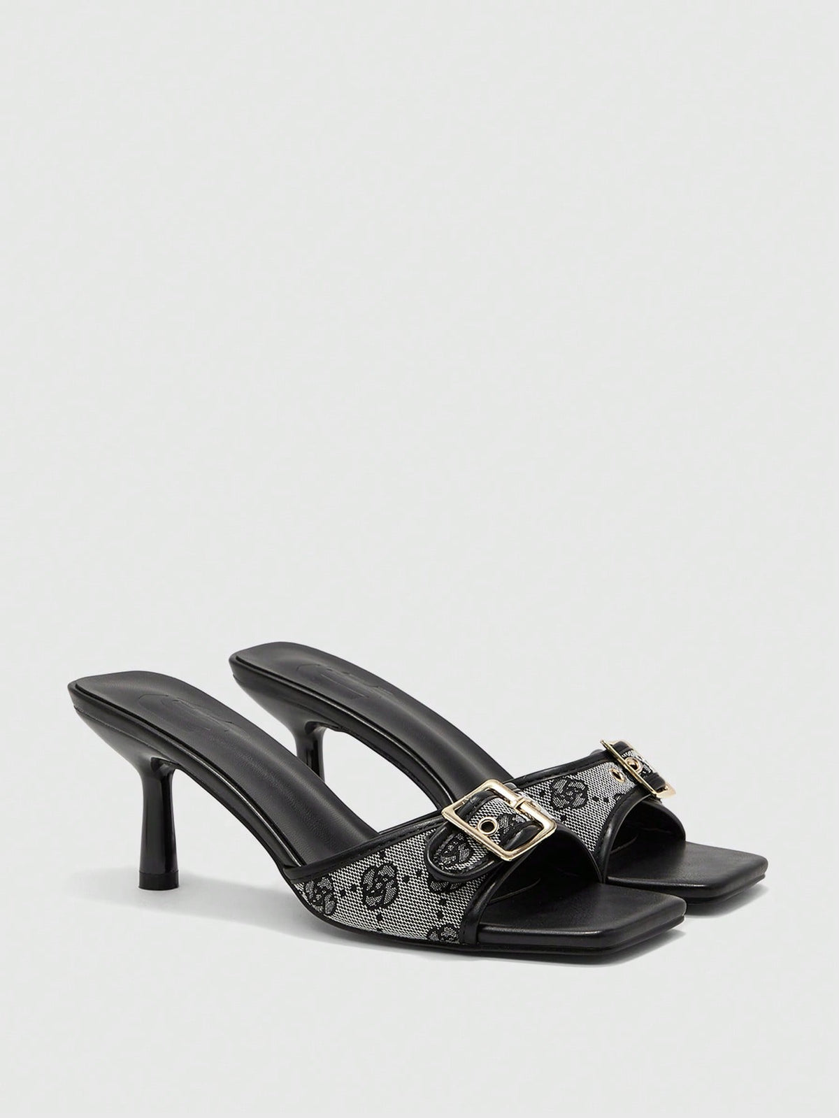 Beige women's slip-on kitten heel slide sandals featuring an accent buckle with grommet eyelets.