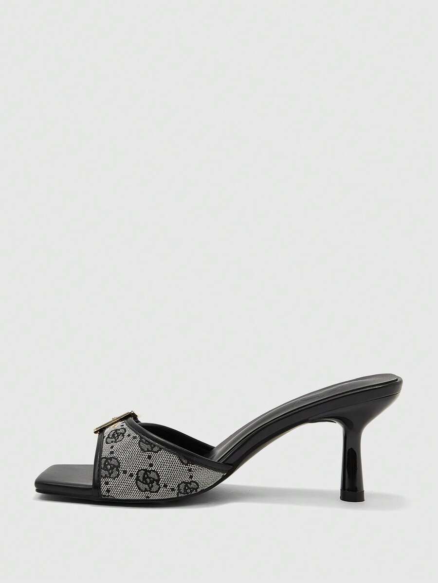 Beige women's slip-on kitten heel slide sandals featuring an accent buckle with grommet eyelets.