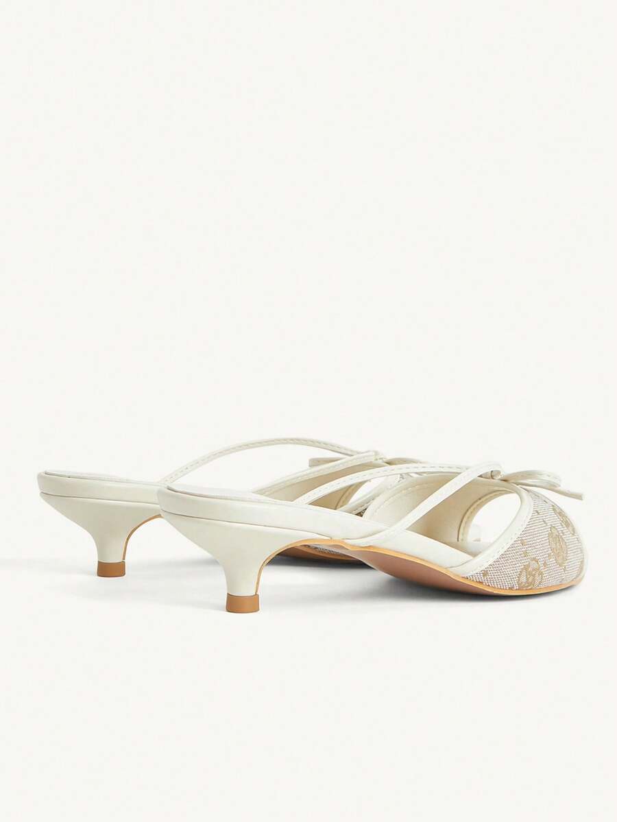 Pointed toe high-heeled slippers in PU leather with decorative buckle detail and low kitten heels for women.