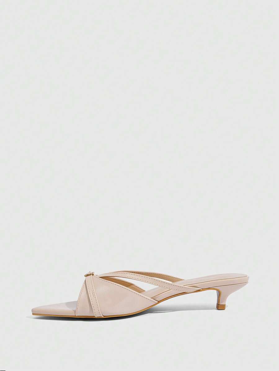 Pointed toe high-heeled slippers in PU leather with decorative buckle detail and low kitten heels for women.